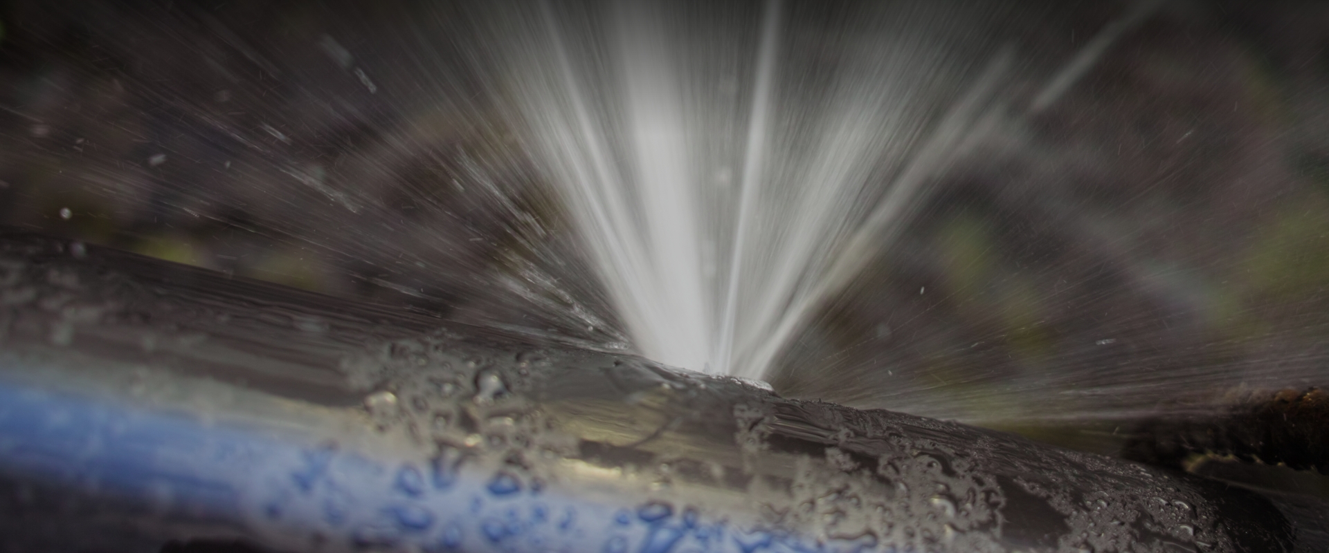 Water spraying from a pressurized pipe leak